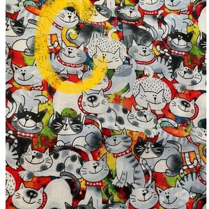May include: A colorful fabric with a repeating pattern of cartoon cats. The cats are drawn in black and white with red collars and are set against a background of red, yellow, green, and blue.
