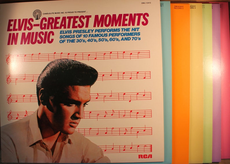 May include: A vintage vinyl record album cover featuring Elvis Presley with the title "Elvis - Greatest Moments in Music". The cover is white with red and black text. The album cover features a photo of Elvis Presley with a black and white background. The album cover also includes a musical staff with red notes.
