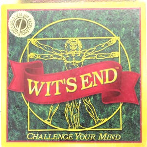 May include: A red and yellow box with a green background. The box has a gold seal with the words "Gold Seal of Excellence". The box also has a drawing of a man with outstretched arms. The text "WIT'S END" is in large red letters on the box. The text "CHALLENGE YOUR MIND" is in smaller letters below the large text.