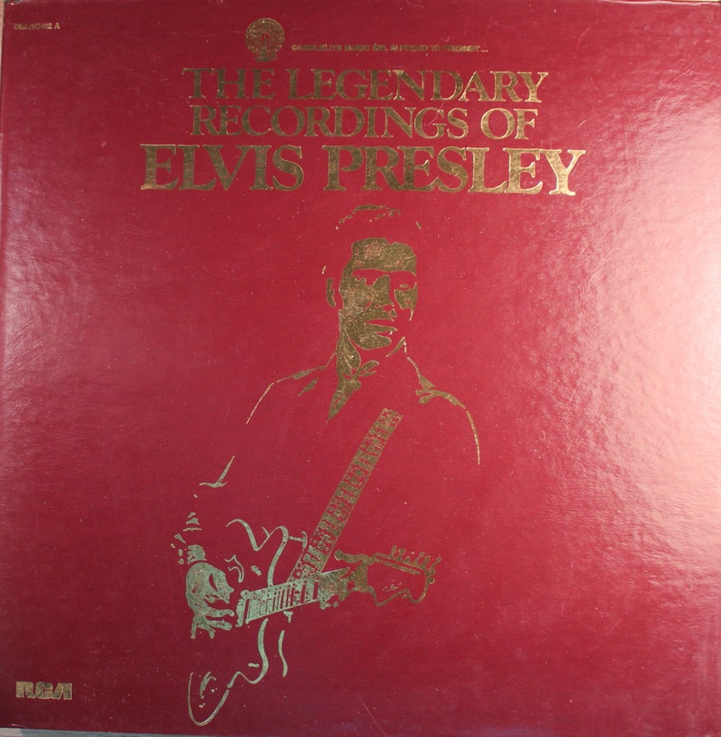 May include: A red vinyl record album cover with gold lettering that reads "The Legendary Recordings of Elvis Presley". A gold silhouette of Elvis Presley playing a guitar is in the center of the cover.