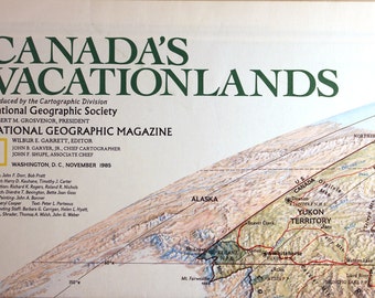 May include: A vintage map of Canada's Vacationlands, produced by the Cartographic Division of the National Geographic Society in November 1985. The map features a detailed illustration of the Yukon Territory, including the Klondike National Historic Site, Whitehorse, and the Ogilvie Mountains. The map also includes a portion of Alaska.