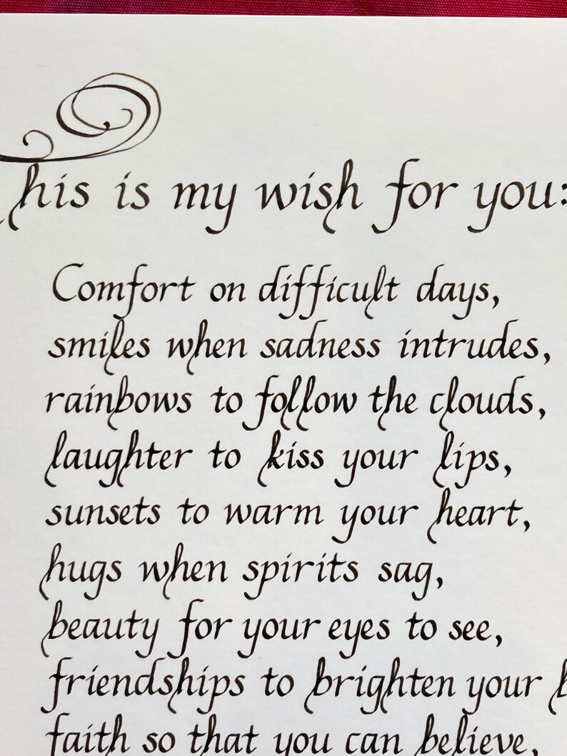May include: A handwritten wish for someone, written in black ink on white paper. The wish includes phrases like "comfort on difficult days", "rainbows to follow the clouds", and "faith so that you can believe".