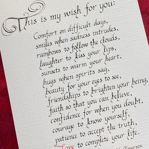 May include: A handwritten quote by Ralph Waldo Emerson about life's challenges and the importance of love, faith, and courage. The quote is written in black ink on a white background with a red heart symbol.