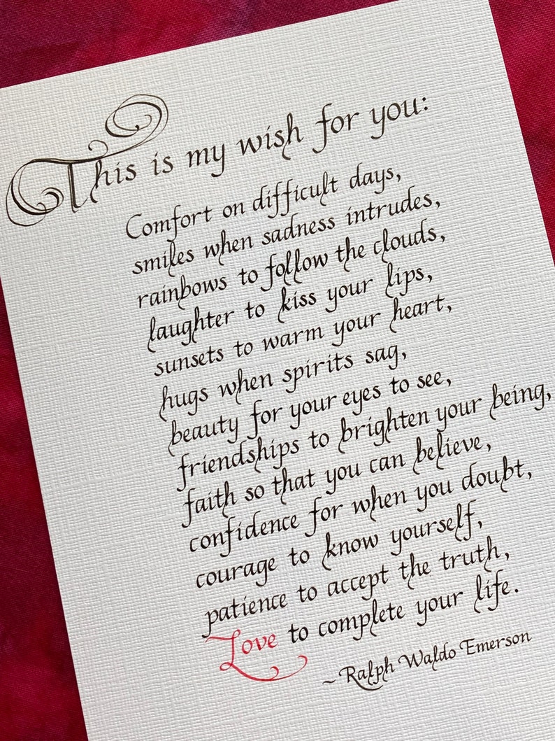 May include: A handwritten quote by Ralph Waldo Emerson about life's challenges and the importance of love, faith, and courage. The quote is written in black ink on a white background with a red heart symbol.