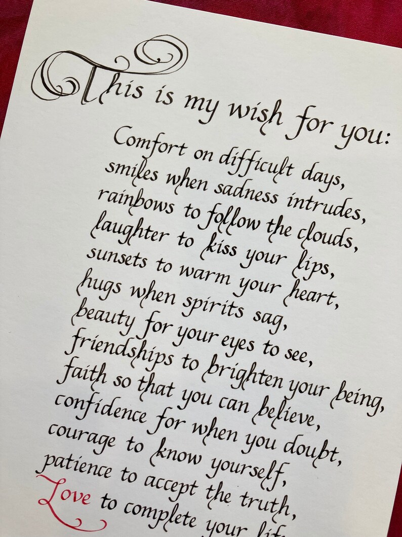 May include: Black ink calligraphy on white paper with the text "This is my wish for you:" followed by a list of wishes for comfort, smiles, rainbows, laughter, sunsets, hugs, beauty, friendships, faith, confidence, courage, patience, and love.