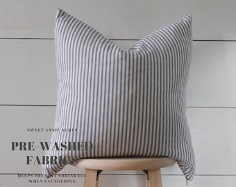 May include: A white and blue striped pillow with the text "Sweet Annie Acres Pre-Washed Fabrics Helps Prevent Shrinkage When Laundering" on the front.