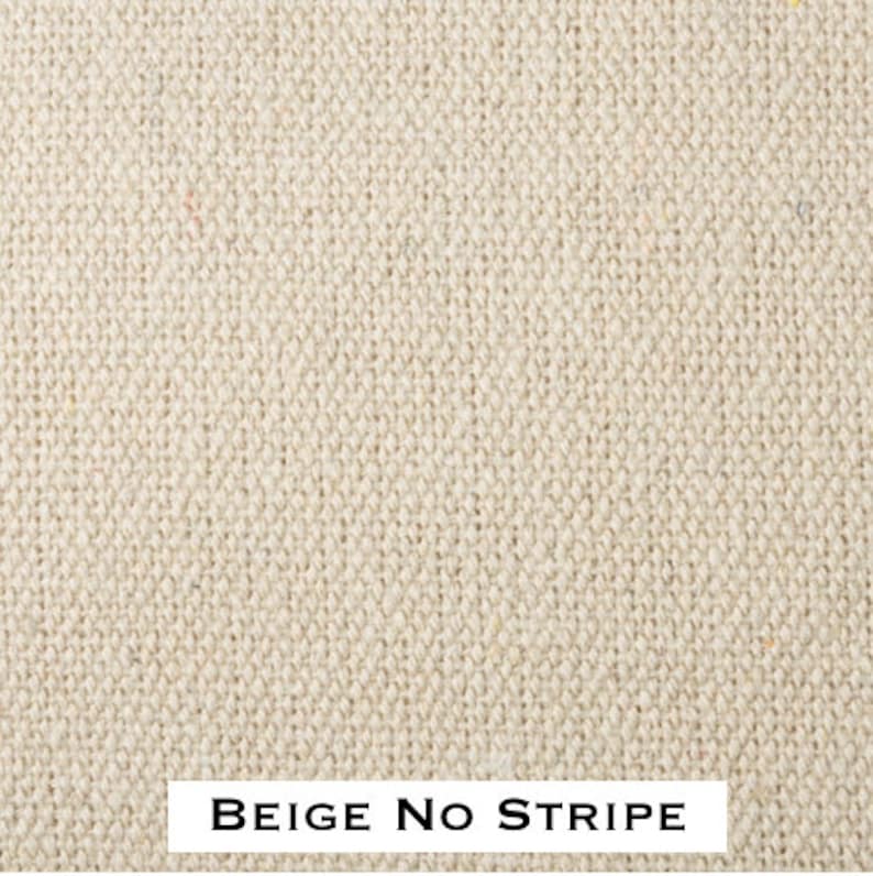 May include: Beige fabric with a woven texture. The fabric has no stripes.