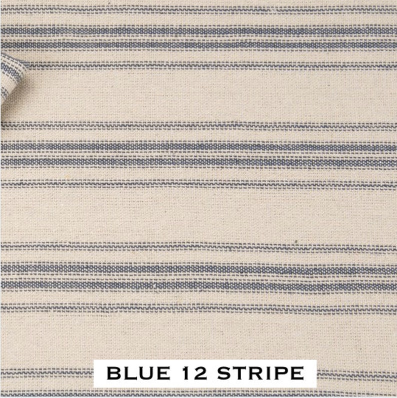 May include: A close-up of a white fabric with blue stripes. The fabric has a woven texture and the stripes are evenly spaced. The text "BLUE 12 STRIPE" is printed at the bottom of the image.