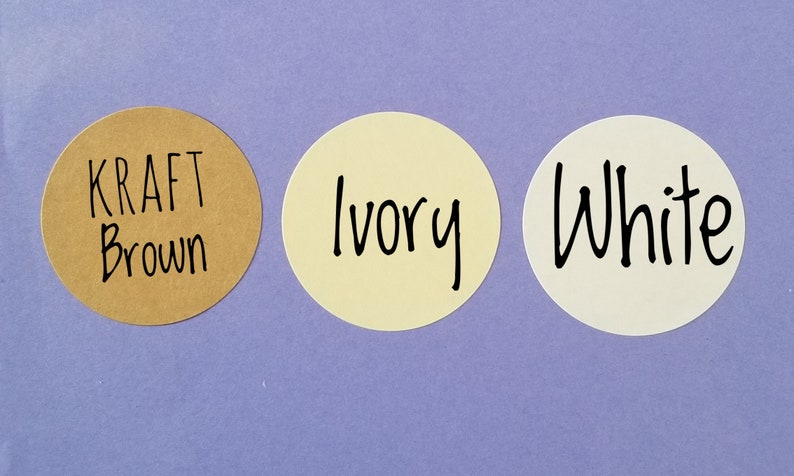 May include: Three round paper stickers with different colors and text. The first sticker is brown with the text "KRAFT Brown". The second sticker is ivory with the text "Ivory". The third sticker is white with the text "White".