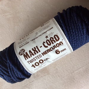 May include: A spool of dark blue Maxi-Cord twisted Herculon rope. The label reads "MAXI-CORD TWISTED POLYPROPYLENE" and "6 mm". The spool contains 100 yards of rope, made in the USA.