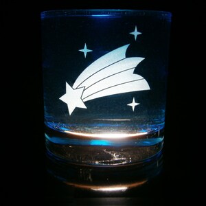 May include: A blue glass tumbler with a white etched design of a shooting star and stars.