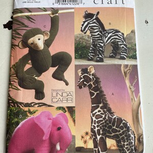 May include: A sewing pattern for making four stuffed animals: a monkey, a zebra, a giraffe, and an elephant. The pattern is from Vogue Crafts and designed by Linda Carr. The pattern number is V8349.