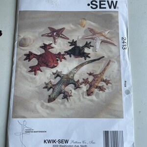 May include: Kwik-Sew Pattern Co., Inc. sewing pattern number 2413 for making a variety of plush toys, including a frog, a lizard, and a starfish. The pattern is designed by Kerstin Martensson.