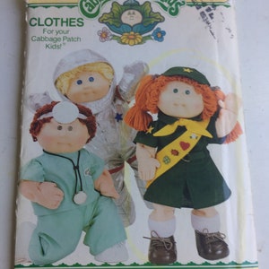 May include: A vintage sewing pattern for Cabbage Patch Kids clothes. The pattern is for making a doctor, astronaut, and scout outfit. The pattern number is 3728. The pattern is by Butterick.