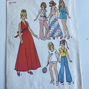 May include: A vintage sewing pattern for a one-size dress, top, skirt, and pants. The pattern is Simplicity 6697 and costs $1.15. The pattern features illustrations of women wearing the different garments.