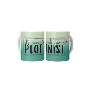 May include: A white ceramic coffee mug with a green ombre design. The mug has a black graphic that reads "it's never too late for a PLOT TWIST" with a small heart symbol.