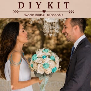 May include: A DIY kit for wood bridal blossoms featuring a bouquet of cream and turquoise wooden roses, small white filler flowers, green leaves, and a white starfish, tied with a light blue ribbon, with the text DIY KIT WOOD BRIDAL BLOSSOMS.