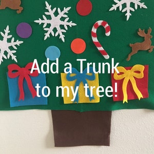 May include: A felt Christmas tree with a brown trunk, red and white candy cane, snowflakes, presents, and reindeer. The text "Add a trunk to my tree!" is written on the tree.