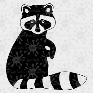 May include: Black and white silhouette of a raccoon with a striped tail. The raccoon is sitting up with its paws in front of it. The background is a light gray with a pattern of black ink splatters.