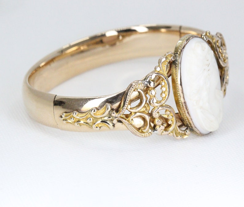 Puede incluir: Un brazalete de oro con un camafeo ovalado engastado en un dise&ntilde;o de filigrana.