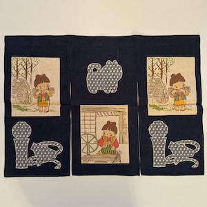 May include: Three panels of dark blue fabric with a white background featuring a girl in a red and white dress and a black and white patterned dog. The panels are decorated with a black and white patterned design.