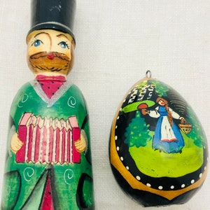 Vintage Set of 2 Black Lacquer Christmas Ornaments Man with Top Hat and Accordion & Russian Egg with Girl in Forest