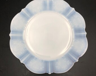 May include: A white milk glass plate with a scalloped edge and a blue and white floral design.