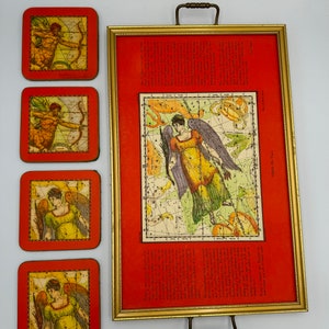 May include: A set of four red coasters with gold trim featuring vintage illustrations of constellations and celestial figures. The coasters are displayed with a larger framed print of a constellation chart with a similar design.