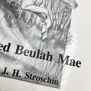 May include: A black and white pencil drawing of a unicorn jumping over a log. The drawing is titled "Loved Beulah Mae" and signed "J. H. Stroschin".