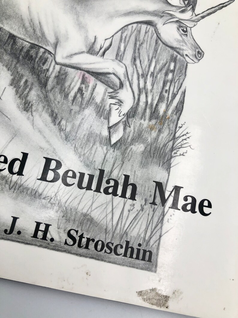 May include: A black and white pencil drawing of a unicorn jumping over a log. The drawing is titled "Loved Beulah Mae" and signed "J. H. Stroschin".