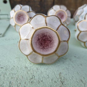 May include: A white ceramic mug with a black handle and the text "But First, Coffee" in a black, handwritten-style font. The mug is on a white surface.