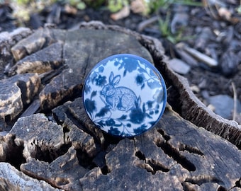 May include: A blue and white ceramic knob with a rabbit design. The knob is round and has a glossy finish.