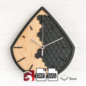 May include: Black and wood clock with a honeycomb design. The clock is shaped like a teardrop and is 3mm thick. The clock is available in DXF and SVG formats.