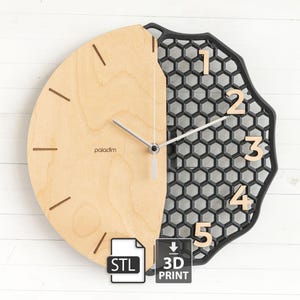 May include: A contemporary wall clock with a distinctive aesthetic. The clock face is divided, with a light wood section displaying minimalist hour markers and the word "paladim". The other half is black with a honeycomb design and wooden numerals. Includes "STL" and "3D PRINT" icons.