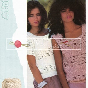 May include: Two women wearing crocheted tops. The woman on the left is wearing a white top with short sleeves. The woman on the right is wearing a pink top with no sleeves. Both tops have a lacy pattern. The text "Patons Linen Look" is visible in the lower left corner of the image.