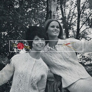 May include: Two women wearing white knitted sweaters with cable knit patterns. The sweaters are from a vintage knitting pattern book titled "The Aran Look" in "Sirdar Sports Wool".