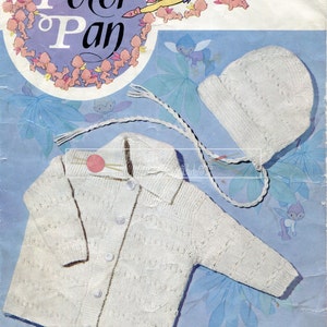 May include: A white knitted cardigan and hat set for a baby. The cardigan has a button closure and the hat has a brim. The pattern is a Wendy design for an 18-20 inch chest and is double knitted.