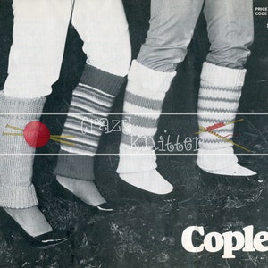 May include: Three pairs of striped leg warmers in white and gray, with one pair of leg warmers featuring a red ball of yarn and knitting needles. The leg warmers are worn by three people, and the image is set against a dark background. The text "crazy knitter" is visible in the image.
