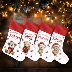 May include: Four Christmas stockings with red tops and white bodies, each personalized with a name: Joshua, Sarah, Vincent, and Sophie. Each stocking features a teddy bear illustration and the text "SPECIAL DELIVERY FOR".