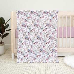Custom baby girl blanket with watercolor wildflowers and butterflies — personalized with name baby name in soft pink and purple tones.