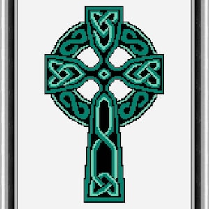 May include: A framed pixel art image of a Celtic cross. The cross features intricate knotwork in shades of teal and black against a white background. The frame is silver and black.
