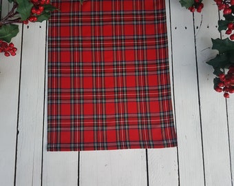 May include: Red and black plaid table runner with a white background. The runner is made of a soft, woven fabric and has a subtle sheen.