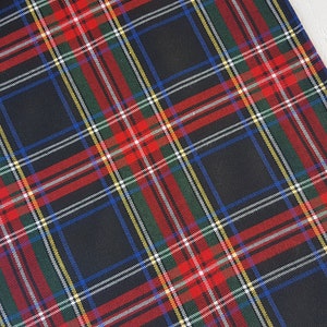 May include: Black and red plaid table runner with green, blue, and white accents. The runner is made of a woven fabric and has a subtle sheen.