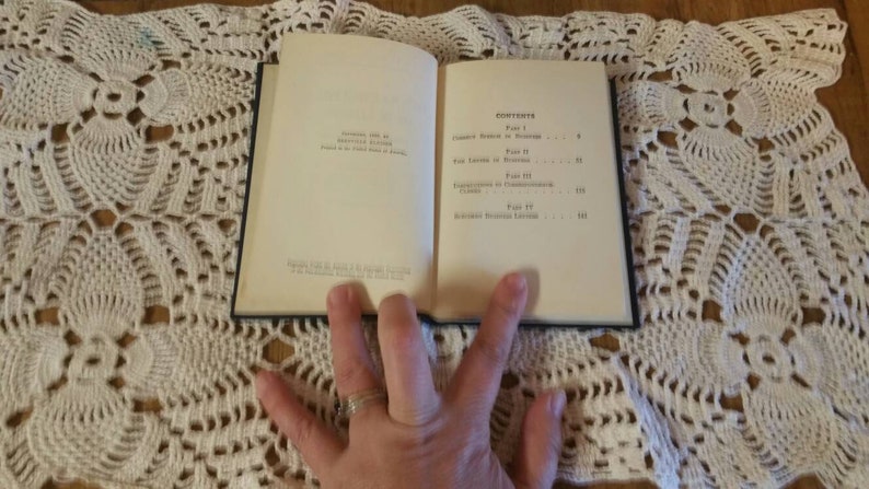 May include: An open book with a white cover and black text. The book's contents include "The Tactics of Peace" and "Negotiated Economic Recovery".