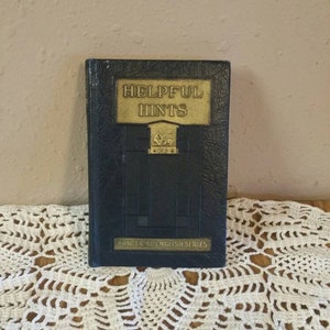 May include: A black book with gold lettering on the cover. The title is "Helpful Hints" and the book is part of the "Practical English Series".