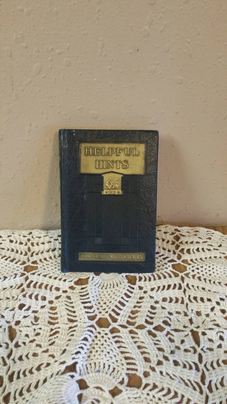 May include: A black book with gold lettering on the cover. The title is "Helpful Hints" and the book is part of the "Practical English Series".