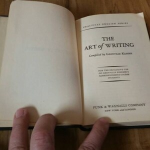 May include: A closed book titled "The Art of Writing" compiled by Grenville Kleiser. The book is part of the Practical English Series and published by Funk & Wagnalls Company, New York and London.