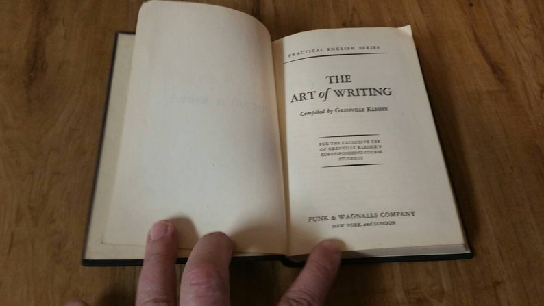 May include: A closed book titled "The Art of Writing" compiled by Grenville Kleiser. The book is part of the Practical English Series and published by Funk & Wagnalls Company, New York and London.