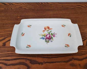 May include: A white rectangular serving tray with a gold trim and a floral design featuring a pink rose, orange tulip, and other flowers in shades of yellow, blue, and green.