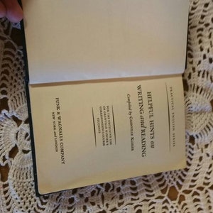 May include: A book titled "Helpful Hints on Writing and Reading" by Grenville Kleiser. The book is part of the Practical English Series and is published by Funk & Wagnalls Company in New York and London.